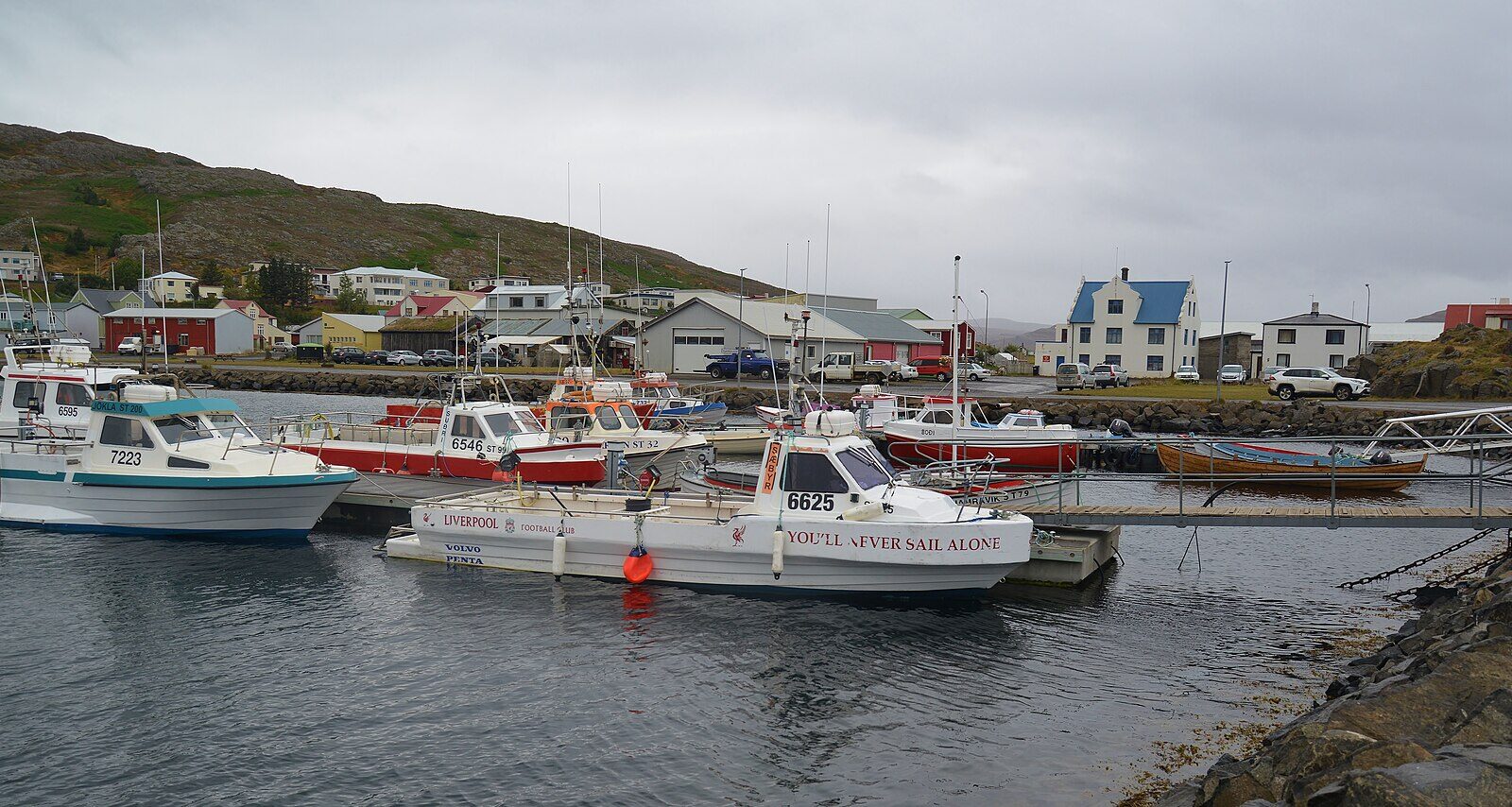 Fishing boats moored in the harbour with waterfront buildings (Hólmavík)