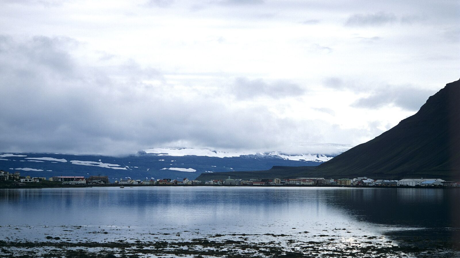 Panoramic fjord view with town across the water and mountains (Ísafjarðarbær)