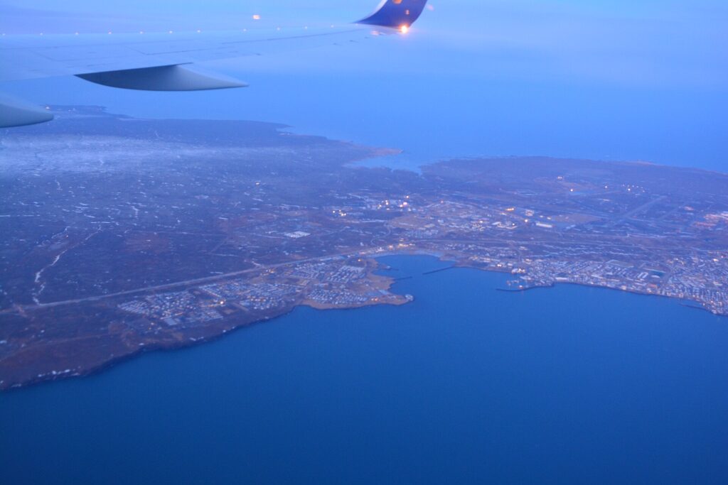 Aerial view of the coastline and harbour from a passenger window (Njarðvík)