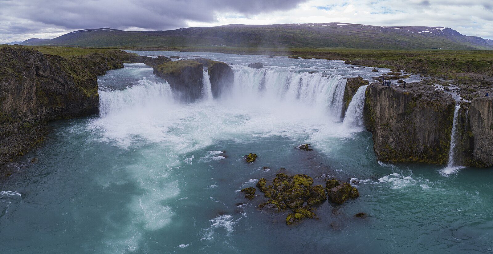Wide view of Goðafoss with cliffs and river