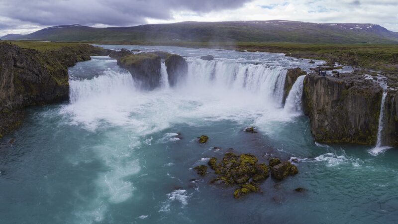 Wide view of Goðafoss with cliffs and river
