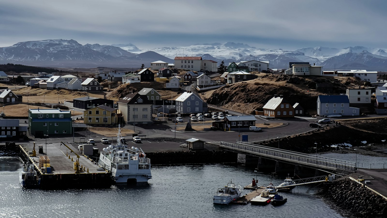 A fishing harbour with mountains behind