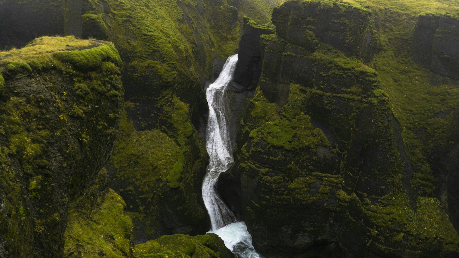 Waterfall over a mossy cliff