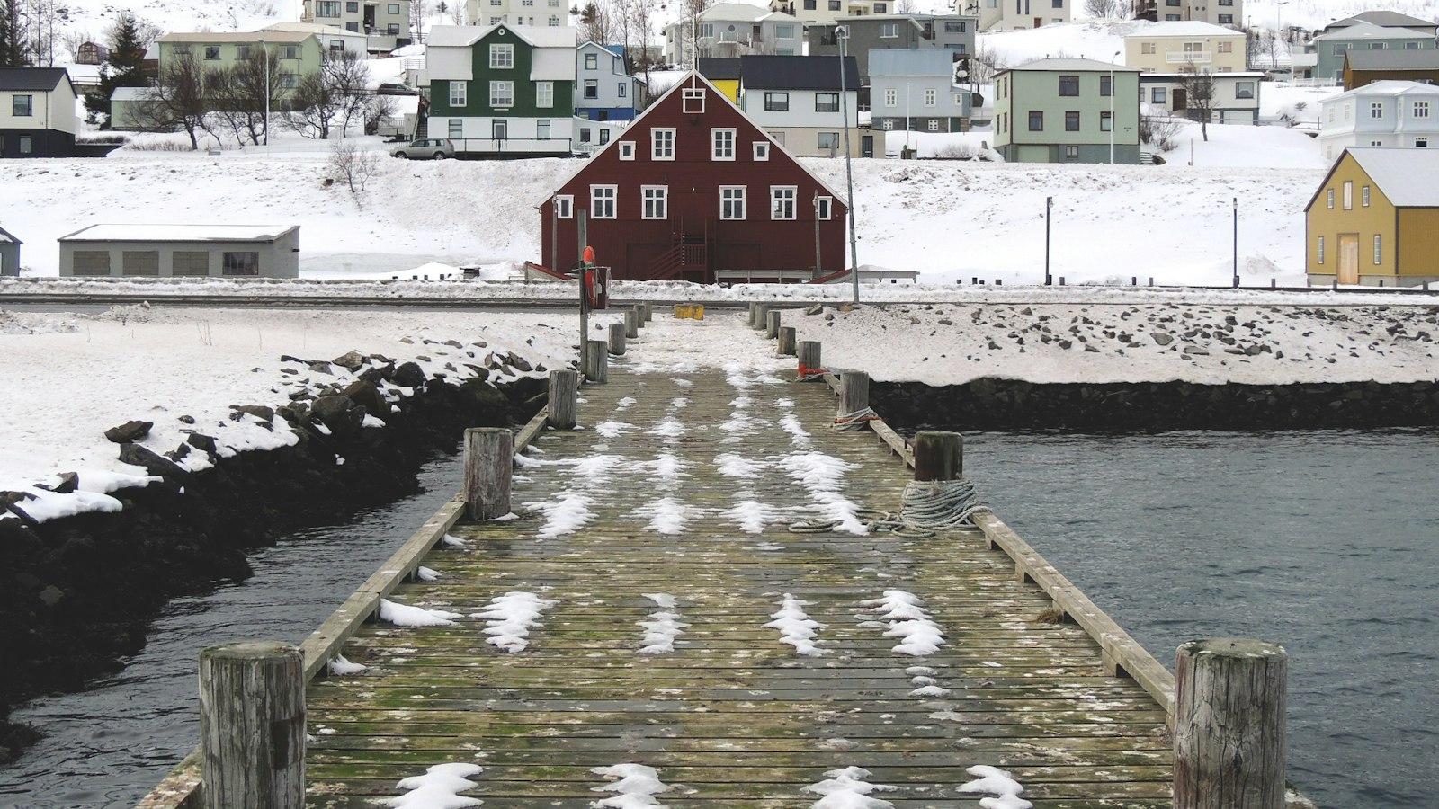 Wooden dock in front of colourful houses