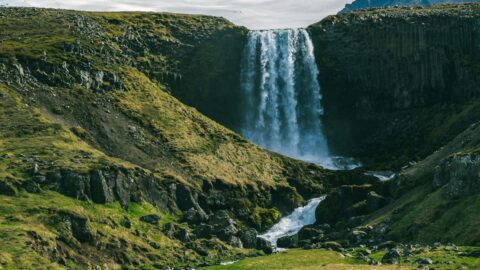 A glacier with a waterfall pouring from its edge