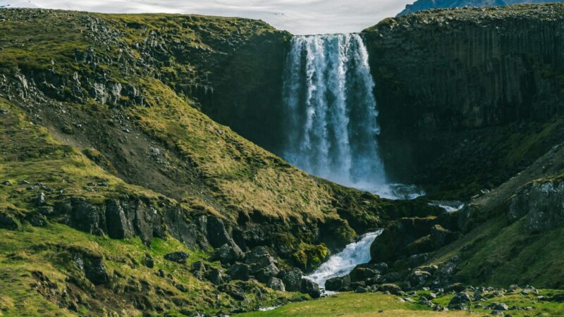 A glacier with a waterfall pouring from its edge