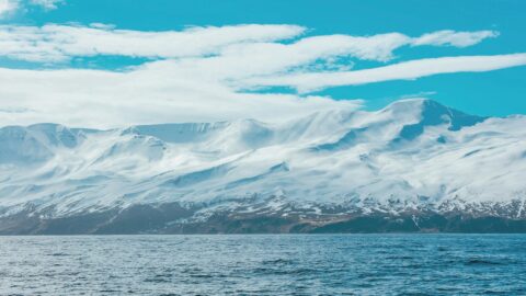 Snow-covered mountain under clouds
