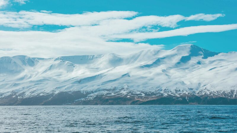 Snow-covered mountain under clouds