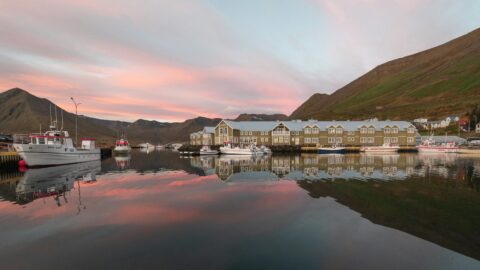 Siglufjörður harbour at dusk reflected in still water