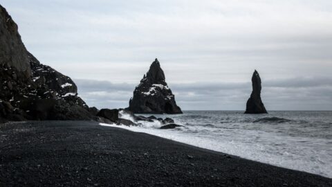 Black rock formations in the sea