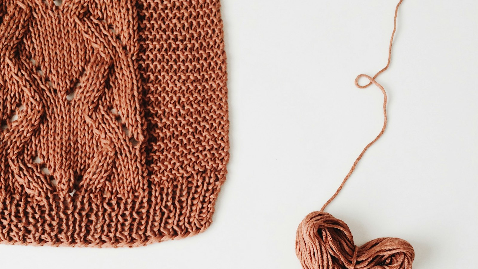 Hand-knitted wool and a ball of yarn