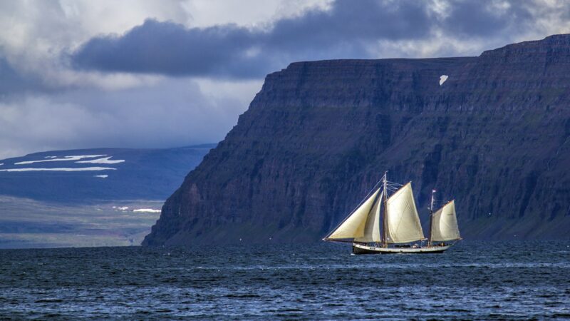 A sailing ship under the cliffs of the Westfjords