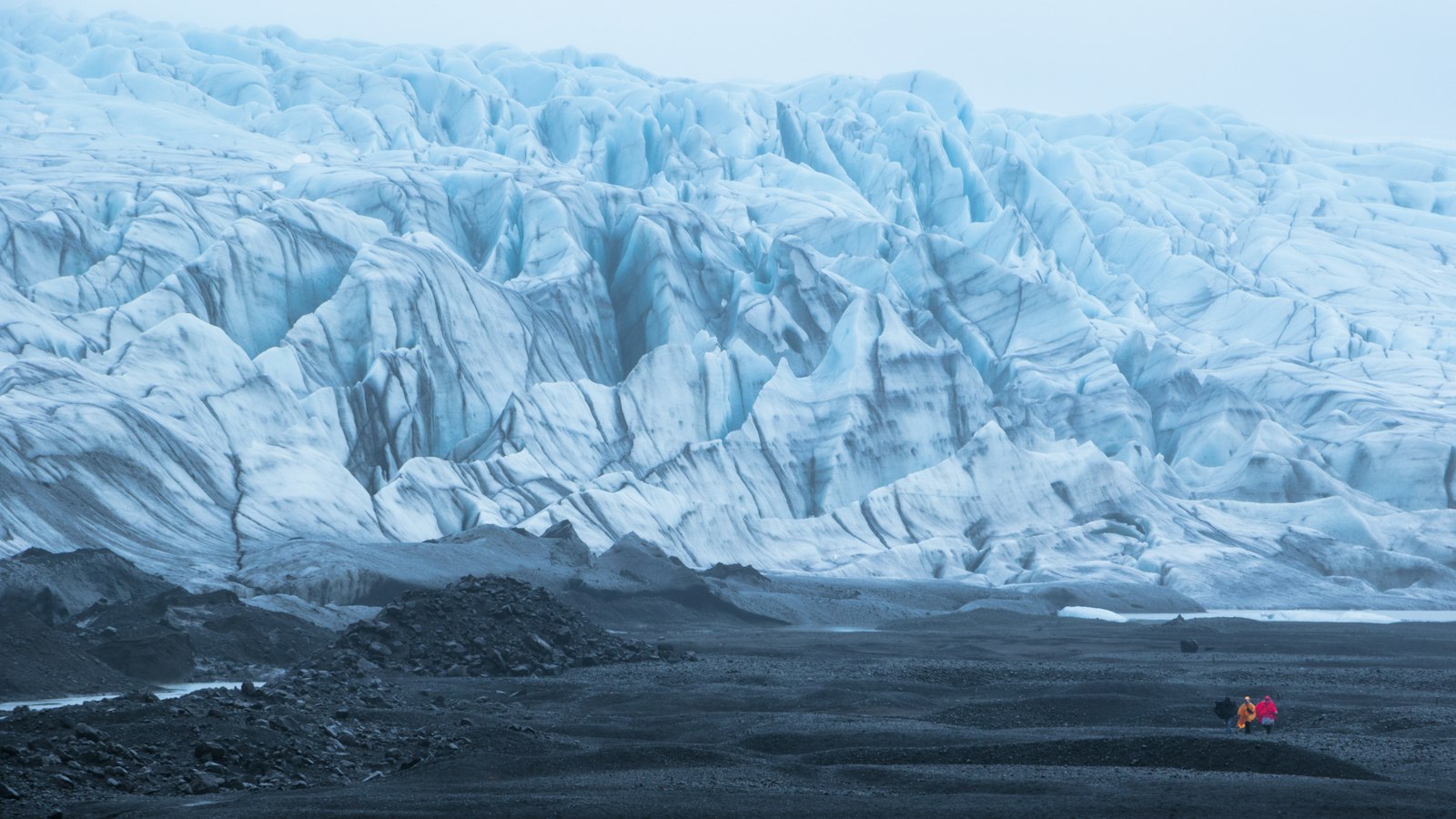 Snow-capped mountain under a pale sky