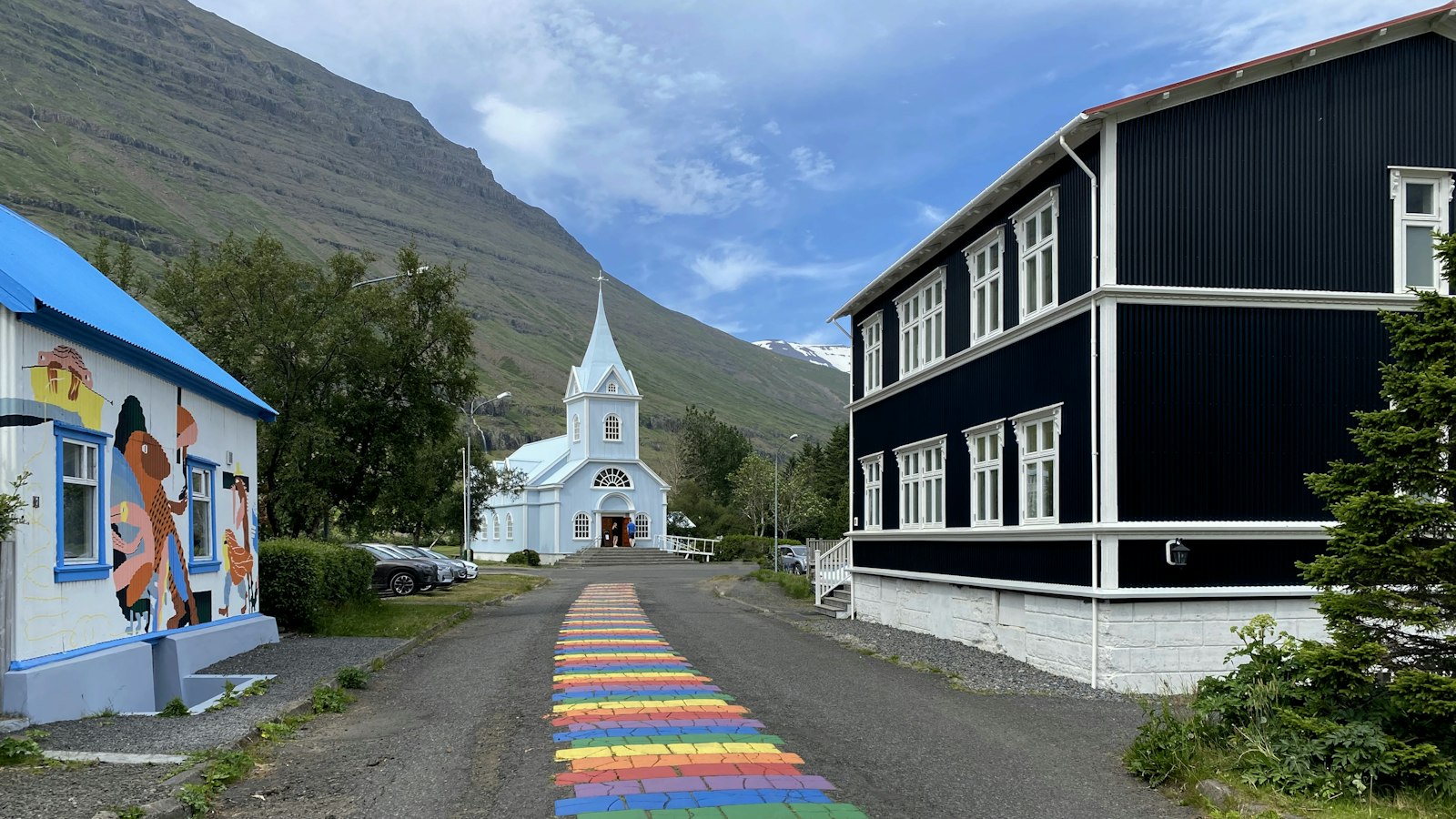 The rainbow street and blue church in Seyðisfjörður