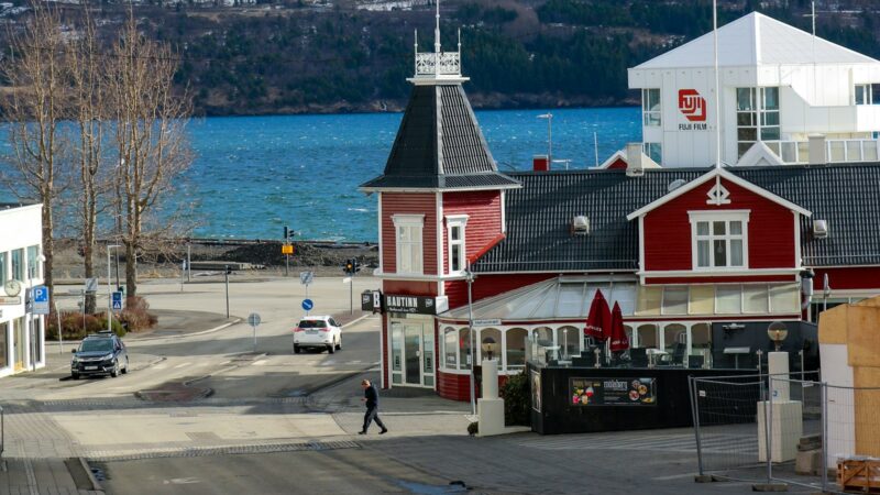 Red buildings and a church in a north Iceland fjord town in winter