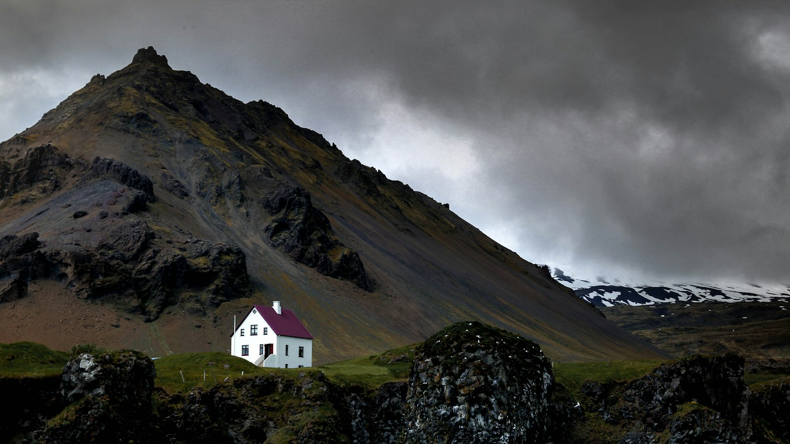 White house near a mountain and water